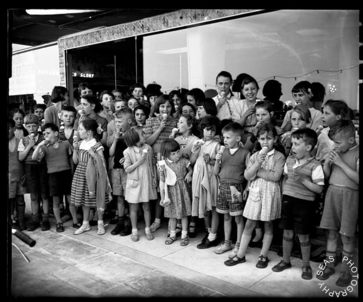 A crowd of children enjoying Morelli's ice cream outside the parlour