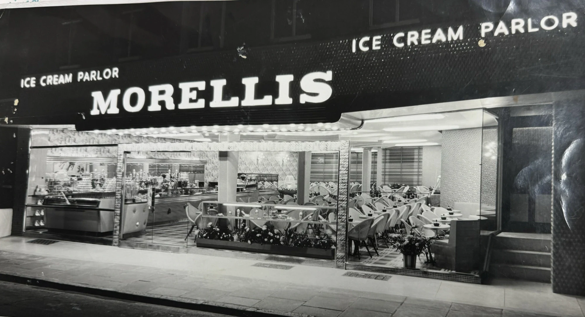 The Morelli's parlour lit up at night in the mid-twentieth century