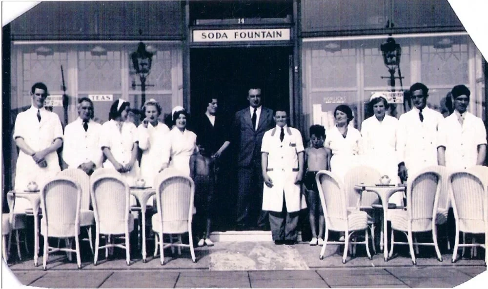 The Morelli's parlour team gathered in the doorway under the Ice Cream Parlor sign