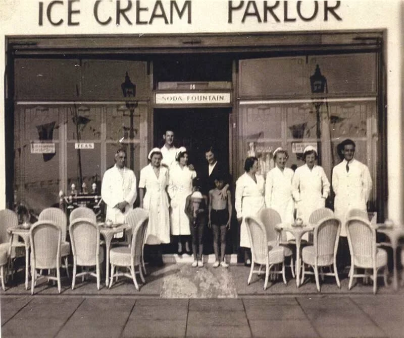 The parlour staff lined up outside the frontage in their whites